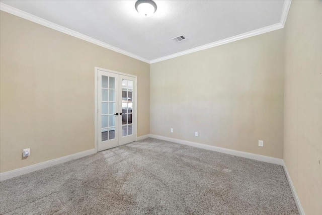 spare room with baseboards, visible vents, ornamental molding, french doors, and light carpet