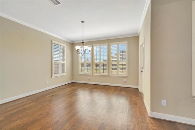 unfurnished room featuring a notable chandelier, visible vents, crown molding, and wood finished floors