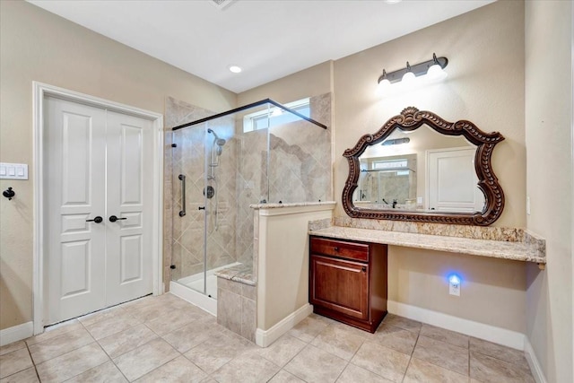 full bath featuring baseboards, a stall shower, and vanity