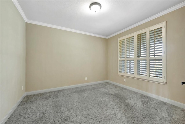 carpeted empty room with baseboards and ornamental molding