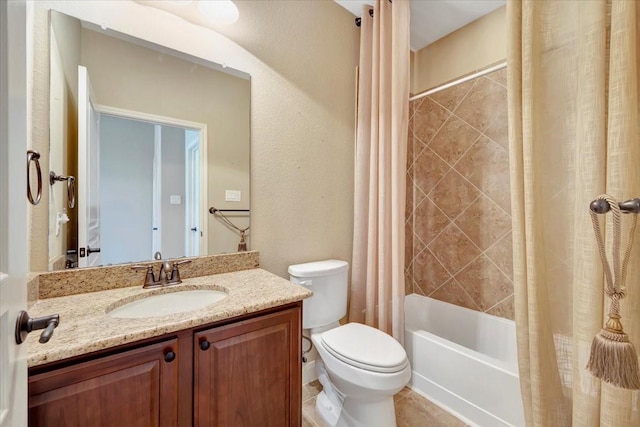 full bath featuring toilet, shower / tub combo with curtain, a textured wall, tile patterned floors, and vanity