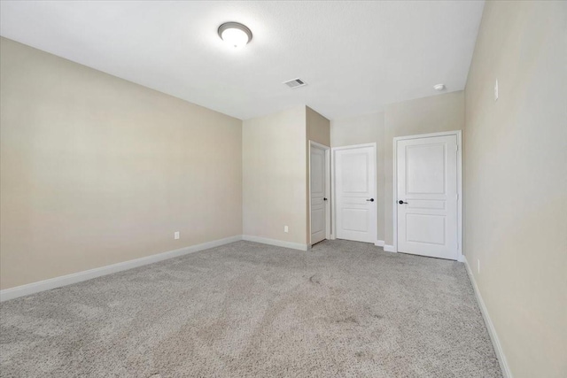 unfurnished bedroom with visible vents, carpet floors, and baseboards