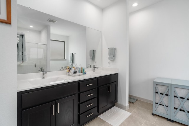 bathroom with tile patterned floors, visible vents, a stall shower, a sink, and double vanity