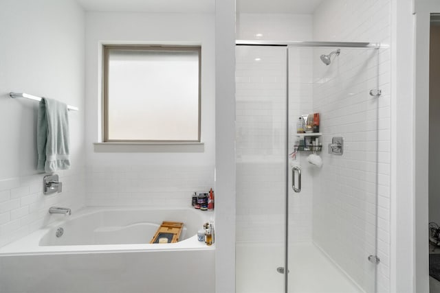 full bathroom with a stall shower and a garden tub