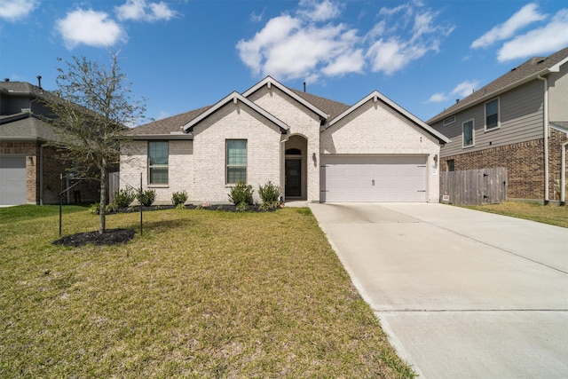 view of front of property with driveway, fence, an attached garage, a front yard, and brick siding