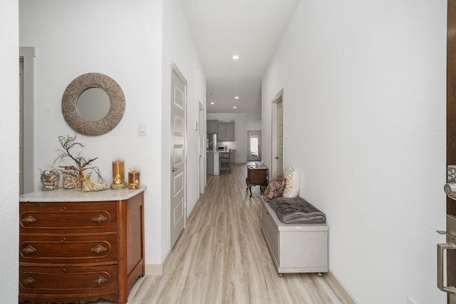 corridor with recessed lighting, light wood-type flooring, and baseboards