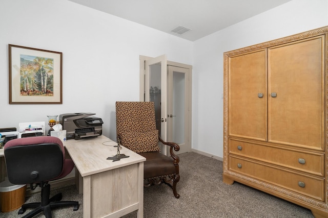 carpeted office featuring visible vents and baseboards