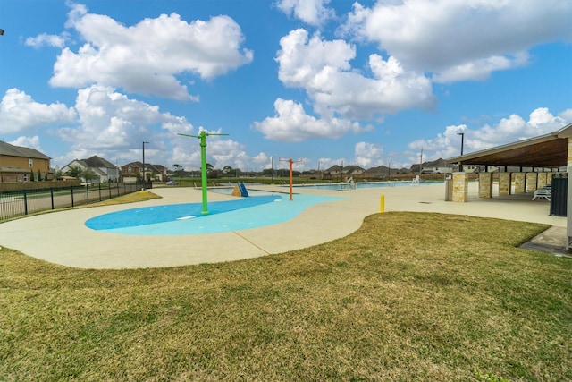 view of home's community featuring a lawn and fence