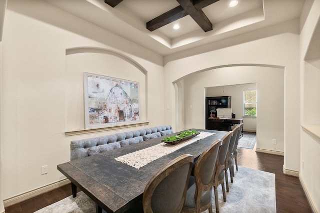 dining area with dark wood finished floors, coffered ceiling, baseboards, and arched walkways