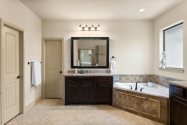 full bath featuring a bath, tile patterned floors, and vanity