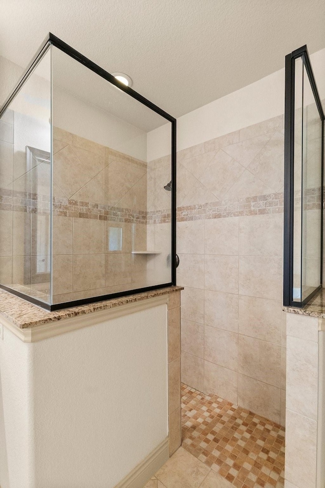 full bath featuring a walk in shower and a textured ceiling