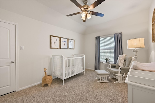 bedroom with a ceiling fan, baseboards, lofted ceiling, a nursery area, and light colored carpet