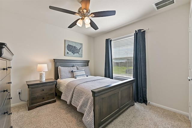 bedroom featuring light carpet, visible vents, a ceiling fan, and baseboards