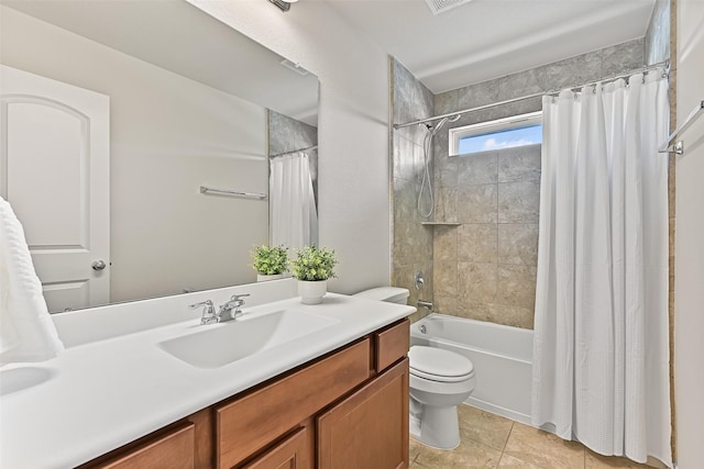 bathroom with tile patterned floors, toilet, vanity, and shower / bath combo