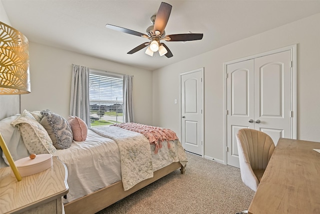 carpeted bedroom featuring a closet and ceiling fan