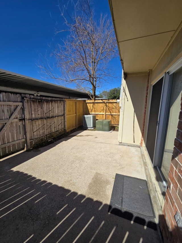 view of patio featuring central AC and fence