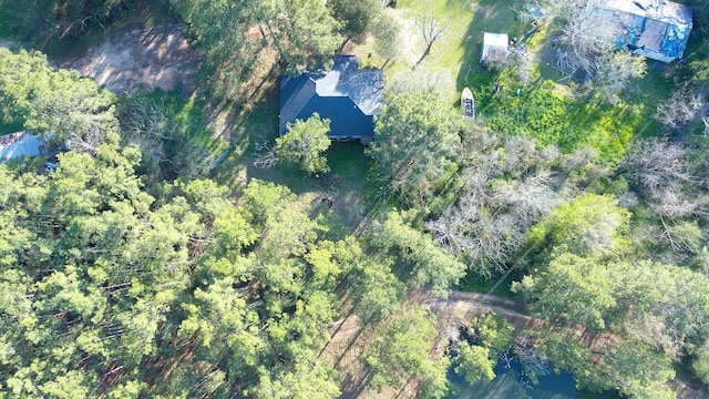 birds eye view of property featuring a view of trees