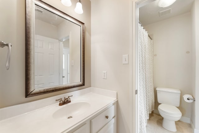 bathroom featuring vanity, tile patterned floors, toilet, and visible vents