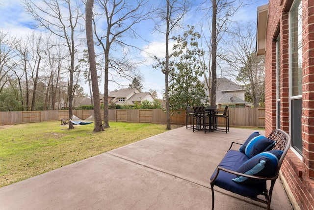 view of patio with a fenced backyard and outdoor dining space