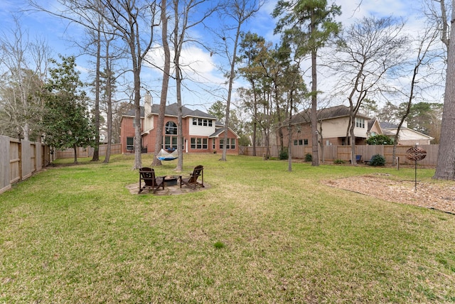 view of yard featuring a fenced backyard and an outdoor fire pit