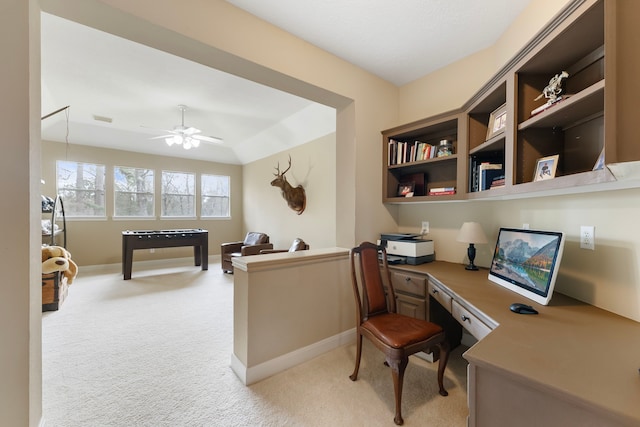 office with visible vents, ceiling fan, baseboards, light carpet, and built in study area