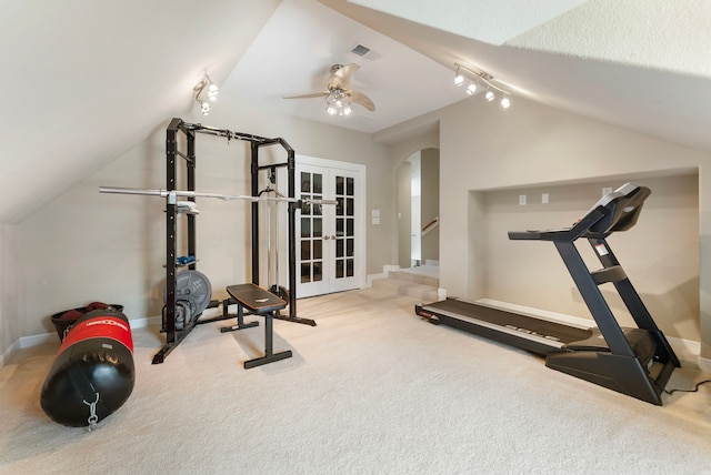 workout area with visible vents, baseboards, carpet floors, vaulted ceiling, and arched walkways