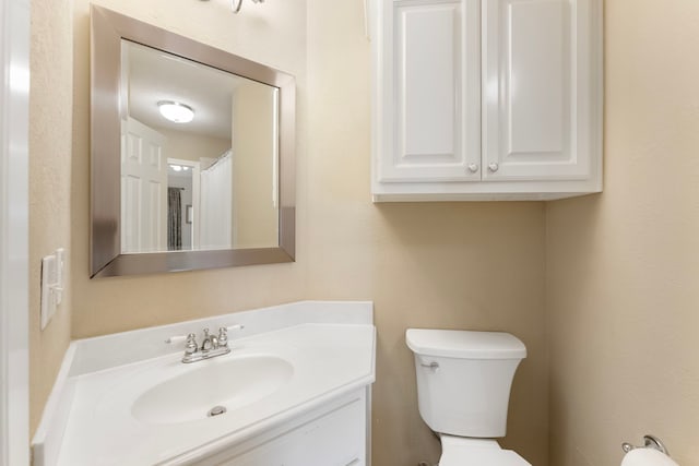 bathroom featuring toilet and vanity