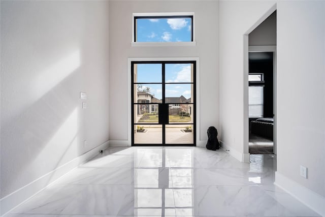 entryway featuring baseboards and marble finish floor