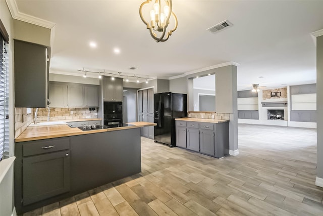 kitchen featuring visible vents, black fridge with ice dispenser, wood counters, and gray cabinets