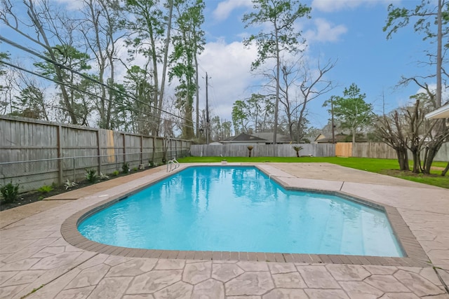 view of swimming pool featuring a patio, a fenced in pool, a lawn, and a fenced backyard