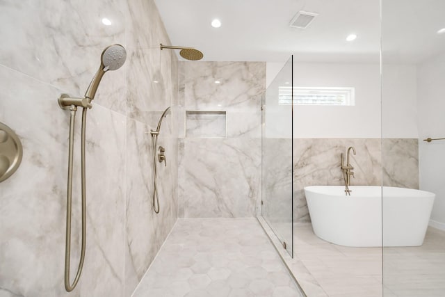 full bath featuring a marble finish shower, visible vents, recessed lighting, and a freestanding tub