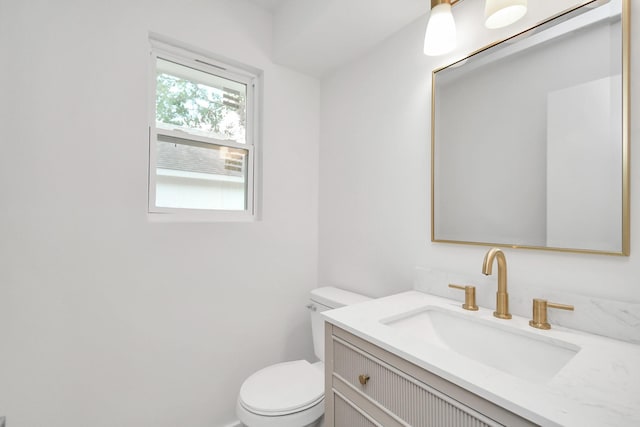 bathroom featuring toilet and vanity