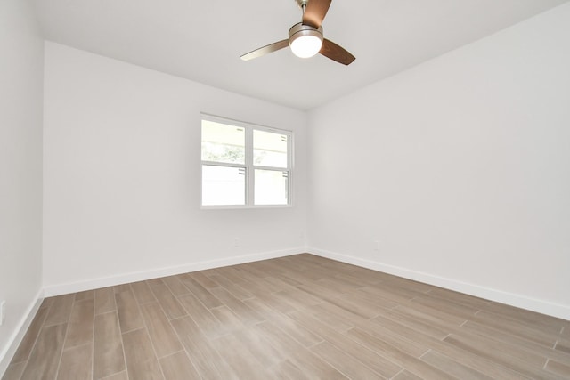 unfurnished room with baseboards, ceiling fan, and light wood finished floors