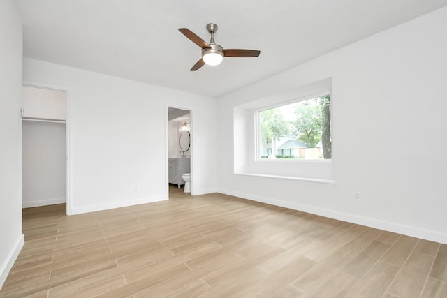 unfurnished bedroom featuring a closet, a ceiling fan, baseboards, and light wood finished floors