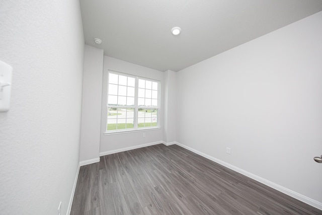 16527 Willow Forest Dr, Conroe, TX 77302 - unfurnished room featuring dark wood-type flooring and baseboards