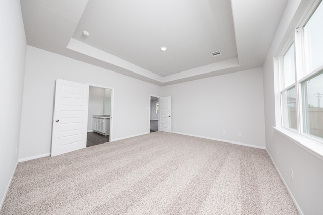 16527 Willow Forest Dr, Conroe, TX 77302 - unfurnished bedroom featuring a raised ceiling, carpet flooring, and baseboards