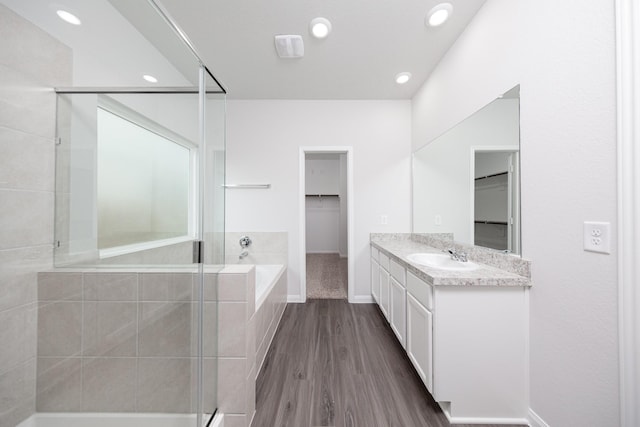 16527 Willow Forest Dr, Conroe, TX 77302 - bathroom featuring a shower stall, a spacious closet, a garden tub, vanity, and recessed lighting