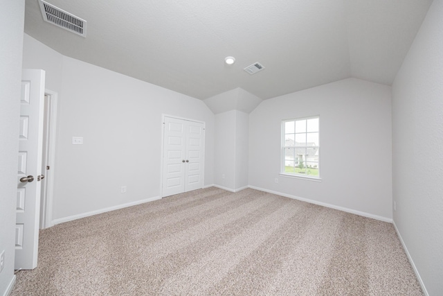 16527 Willow Forest Dr, Conroe, TX 77302 - empty room featuring carpet flooring, lofted ceiling, and baseboards