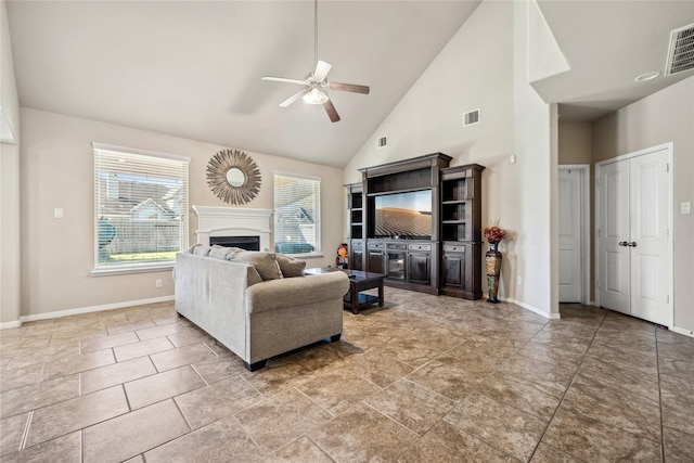 living area with baseboards, a fireplace, visible vents, and ceiling fan