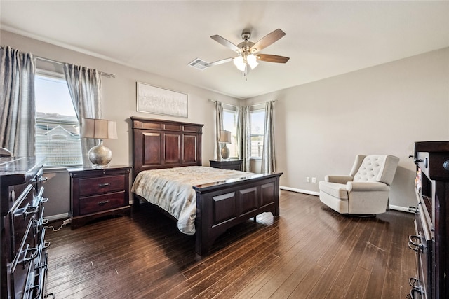 bedroom with dark wood-style floors, visible vents, multiple windows, and baseboards