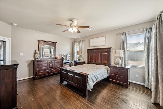 bedroom with dark wood-style floors, visible vents, a ceiling fan, and baseboards