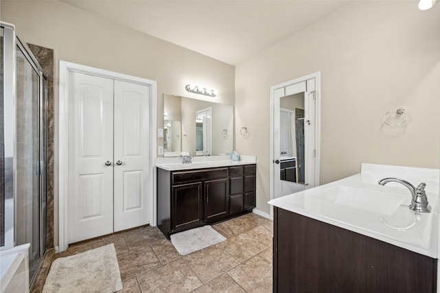 full bathroom with vanity, a shower stall, and a closet