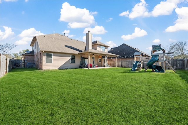 back of property featuring a patio area, a playground, a fenced backyard, and a lawn