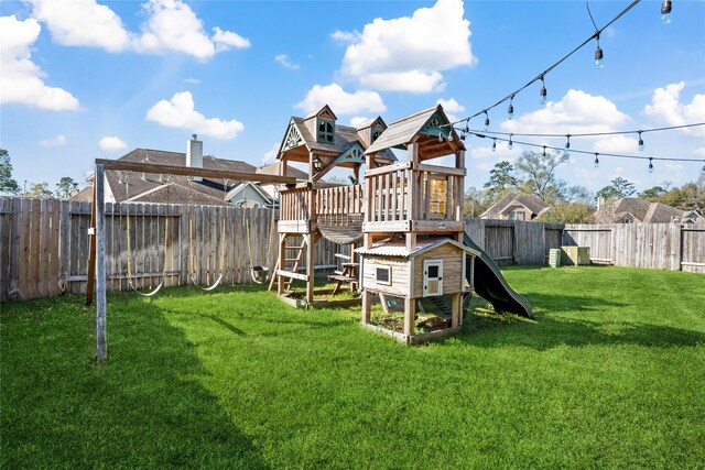 view of play area featuring a lawn and a fenced backyard