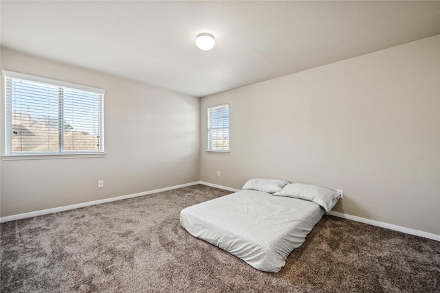 carpeted bedroom featuring baseboards