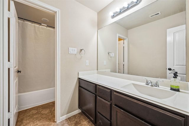 bathroom with tile patterned floors, visible vents, vanity, and baseboards