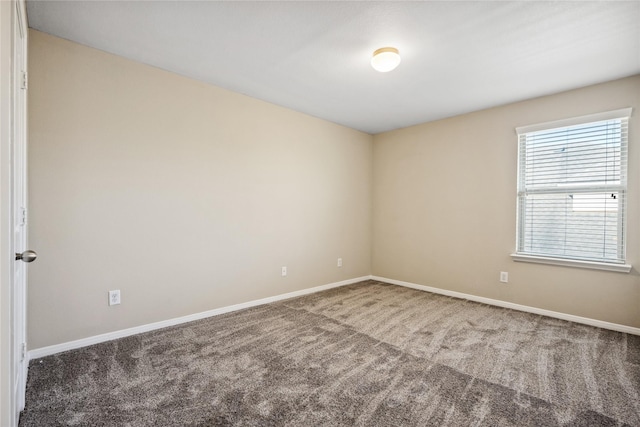 carpeted spare room with baseboards