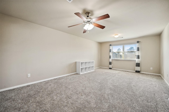 unfurnished room with baseboards, carpet floors, and a ceiling fan