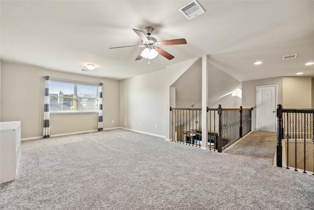 spare room with visible vents, baseboards, ceiling fan, and carpet flooring