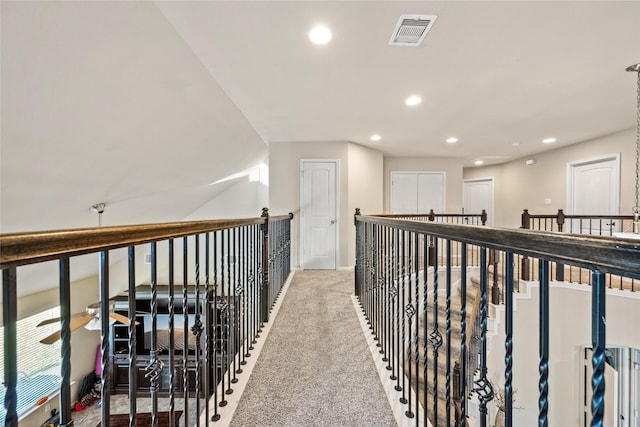 hallway featuring recessed lighting, visible vents, and carpet flooring